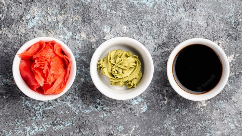 flat-lay-ginger-wasabi-soy-sauce-bowls_23-2148377511