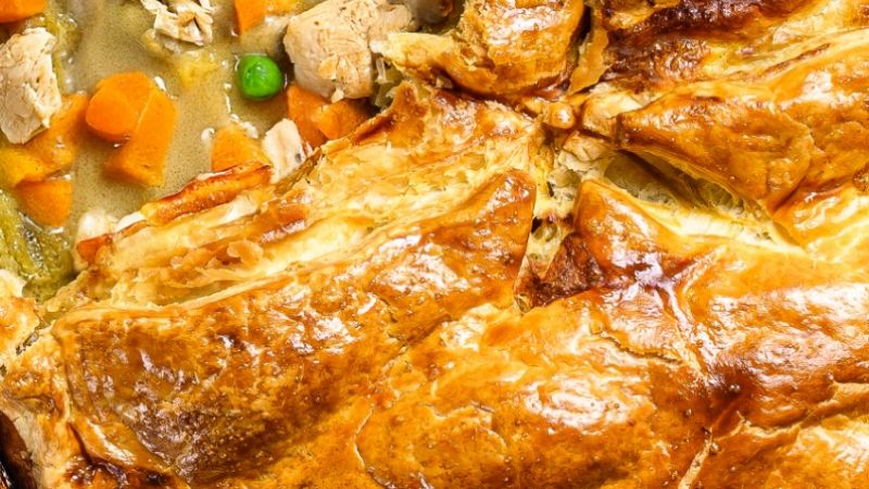 hearty-homemade-chicken-pot-pie-with-peas-carrots-gray-background-top-view